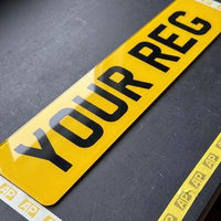 Yellow 2D rear number plate showing the flat printed characters