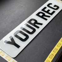 White 2D front number plate showing the flat printed characters