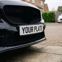 White 2D front number plate fitted to a black car