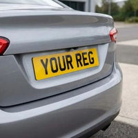 Yellow 2D rear number plate fitted to a silver car