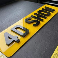 Yellow 4D show plate close up, showing the depth of the raised laser cut letters