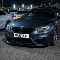 White 4D show plate fitted to a BMW M4 at an evening car meet