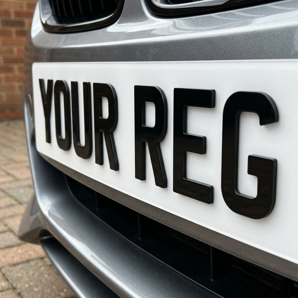 White front number plate fitted to a car, characters shown close up