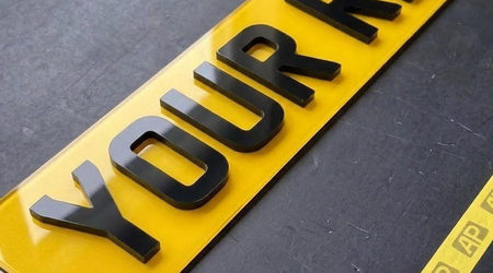 Yellow 4D number plate close up, raised laser cut letters standing proud of the plate