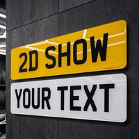 Yellow and white 2D show plates mounted on a garage wall as a display